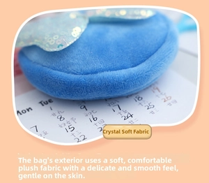 Close-up of soft blue plush crystal fabric texture on a round bow coin purse