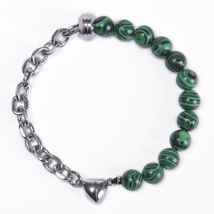 Detail of beaded bracelet featuring green malachite beads and heart magnetic clasp