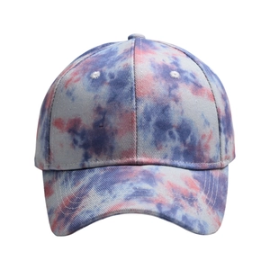 Detail of colorful blue and pink tie-dye baseball cap fabric with stitched eyelets