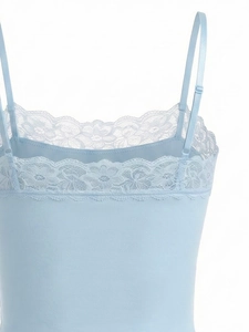 Detail of light blue lace trim on a thin seamless bralette with adjustable straps