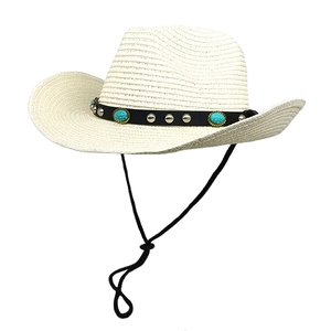 Detail view of a white woven cowboy hat with turquoise gems and silver metal rivets