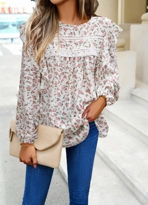 Detail of floral chiffon blouse with lace patchwork and elegant shoulder ruffles