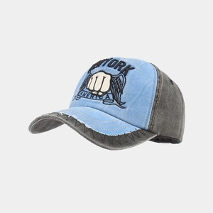 Detail of vintage washed cotton baseball cap with fist embroidery and distressed brim edge