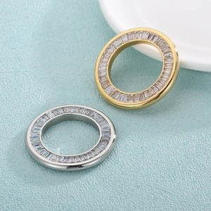 Golden and silver circular pendants with baguette-cut zircons for jewelry making