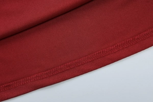 Macro shot of high-quality overlock stitching on a dark red sleeveless dress fabric