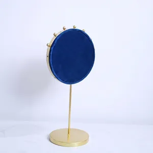 Nordic velvet jewelry display stand with gold base in navy blue and pink reversible design