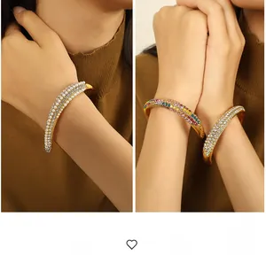 Detail of gold-tone open cuff bracelet with three rows of pearls and sparkling cubic zirconia