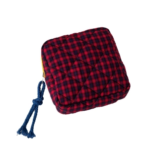 Quilted red and black plaid cosmetic bag with yellow zipper and blue rope puller