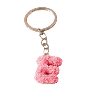Pink floral letter E keychain with golden metal ring on a clean white background