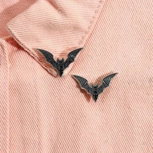 Gothic bat pins in black and silver finish set on pink denim jacket for Halloween decor