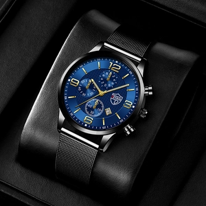Detailed macro view of the blue dial watch with luminous hands and black mesh band
