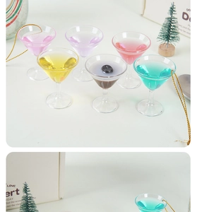 Close-up of colorful miniature cocktail glass ornaments with golden hanging strings