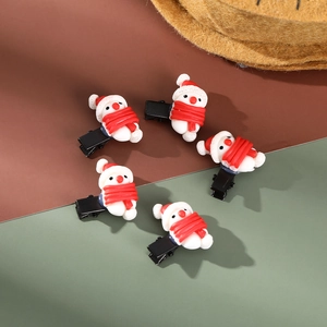 Detailed close-up of five snowman hair clips with red scarves and festive winter design