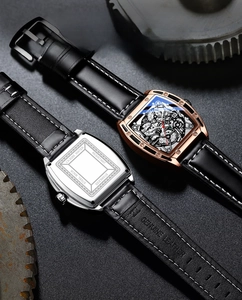 Macro view of mechanical style skeleton dial and stainless steel back on tonneau watch