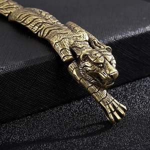 Macro shot of vintage gold tiger head bracelet with detailed fur texture on leather