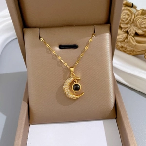 Gold moon pendant necklace with micro-paved zircons and projection stone in a gift box