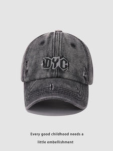 Close-up of DYC embroidery and distressed denim texture on a vintage baseball cap