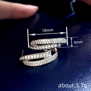 Irregular silver geometric earrings with pavé zircons measuring 18mm by 6mm size