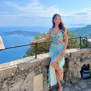 Detail of mint green printed two-piece set featuring V-neck top and high slit skirt