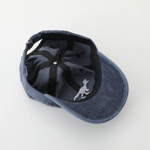 Blue washed denim baseball cap with white dinosaur skeleton embroidery and adjustable metal buckle