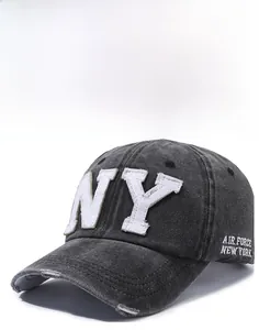 Close-up of washed gray denim baseball cap with white NY embroidery and worn edge detail
