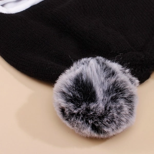 Dettaglio ravvicinato della trama a maglia e del pompon di pelliccia per bimbi