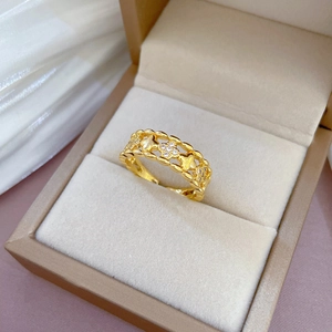 Luxurious 18K gold-plated open ring featuring a hollow clover pattern and white zircons