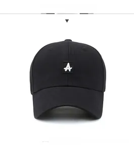 Detail of white embroidered A letter on a black cotton twill baseball cap with curved brim