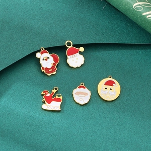 Detail of five festive enamel Santa Claus and sleigh pendants for DIY Christmas jewelry