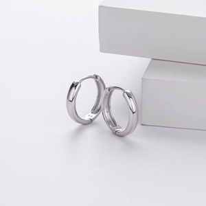 Macro shot showing the 925 sterling silver hallmark on minimalist hoop earrings