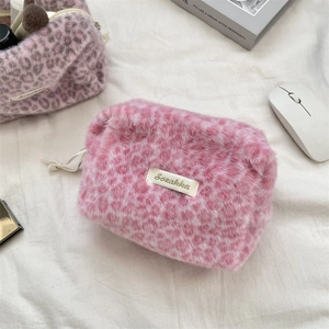 Close-up detail showing the soft pink leopard print plush texture of this cosmetic bag