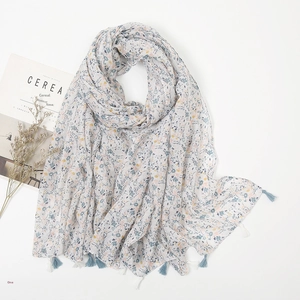 Close-up of floral print cotton linen scarf with blue and beige tassel fringe edge
