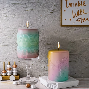 Detailed relief pattern on burning cylinder aroma candles with floral scroll gradients