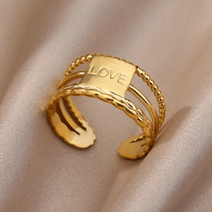 Detailed close-up of 18k gold plated stainless steel ring with LOVE engraving and beads