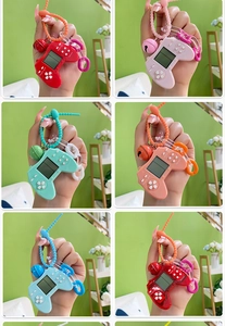 Mini retro handheld game console keychains in multiple vibrant colors with silicone straps