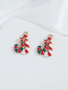 Close-up of Christmas boot charms with red enamel and gold bow for DIY jewelry making