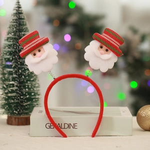 Detail of Christmas headband with Santa dolls on spring decorations and festive background