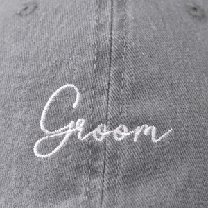Washed grey baseball cap featuring white embroidered Groom text in a minimalist style