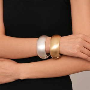 Exaggerated minimalist wide metal cuff bangle in matte gold and silver finish