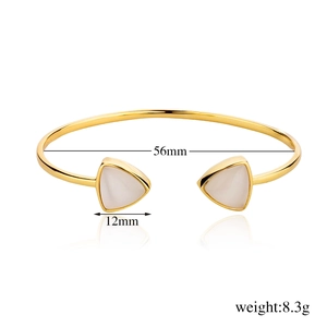 Detailed view of gold open bangle with white triangle stones and size measurements