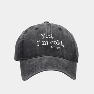 Detailed close-up of vintage washed grey baseball cap with white embroidered text