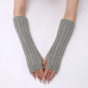 Detailed close-up of grey cable-knit texture on long fingerless winter arm warmers
