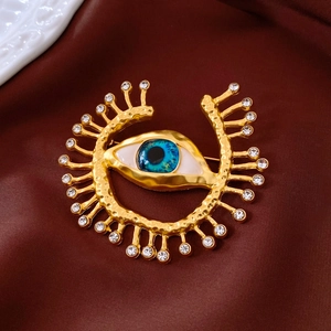 Macro shot of eye-shaped vintage brooch with blue iris and sparkling crystals detail