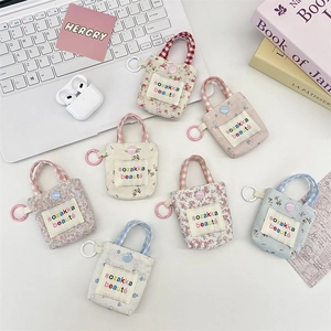 Detailed view of floral canvas mini tote earphone bags for storage with hooks