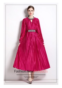 Detail of beaded rhinestone neckline and metallic pleated fabric on rose red dress