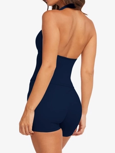 Back view of women's navy blue halter neck yoga set with racerback top and shorts