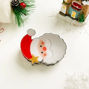 Detailed close-up of a festive Santa Claus hair claw clip with a red hat and gold stars