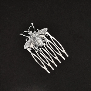 Silver vintage bee shape alloy hair comb hair accessory on a plain black background