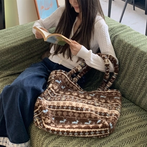 Detail of plush tote bag with ethnic jacquard pattern in a cozy lifestyle setting