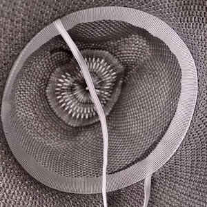 Detail view of woven straw hat interior featuring sweatband and adjustable chin strap